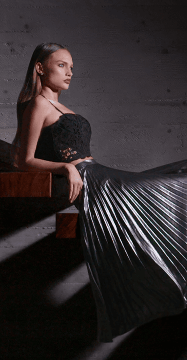 Elegant model seated on wooden staircase
